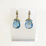 Barbara Heinrich Earring; Facetted blue topaz drops 22.83 with leaf caps containing a single round diamond .03 cttw. Leaf ear wires.